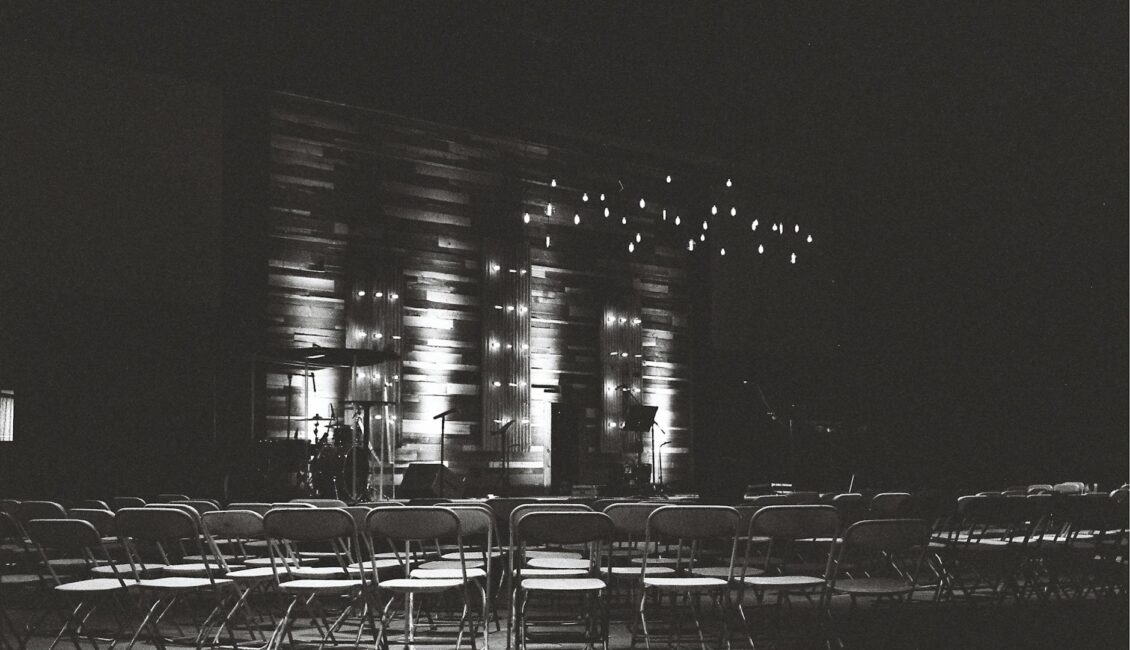 grayscale photography of chairs in an auditorium