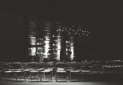 grayscale photography of chairs in an auditorium