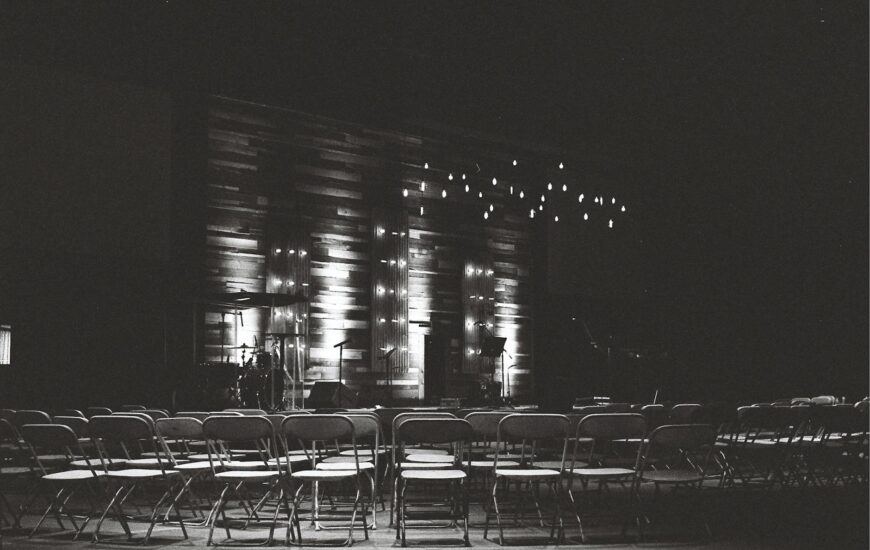 grayscale photography of chairs in an auditorium