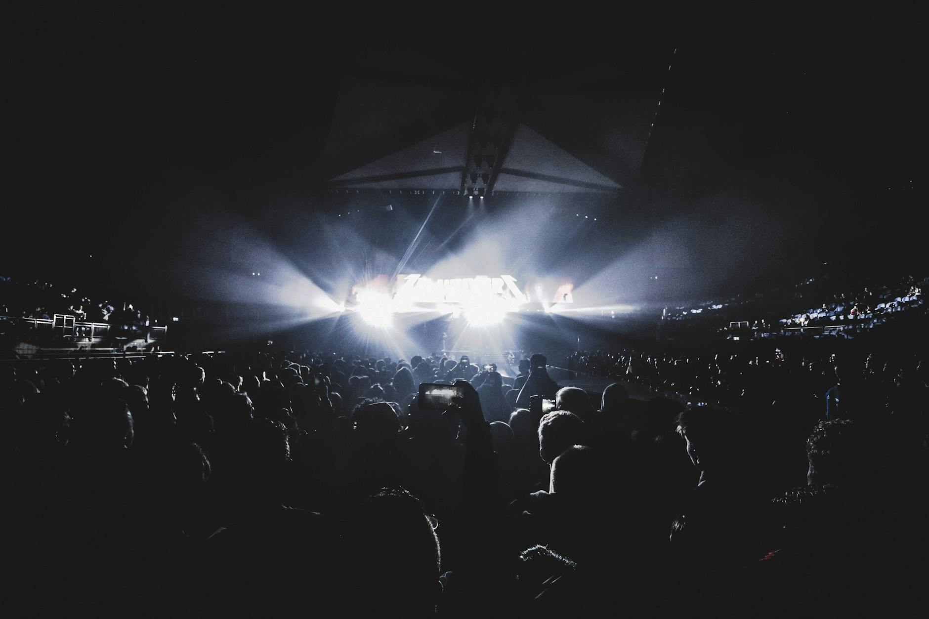 crowd watching show inside the dark stadium